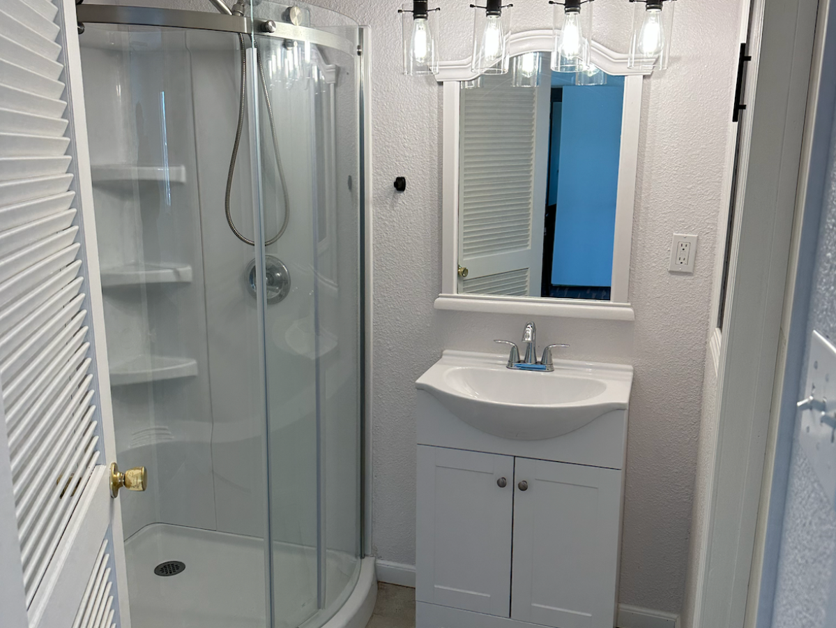 a room with a sink and a mirror